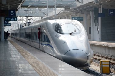 A CRH (China Railway High-speed) bullet train stops at the Nanning Railway Station on the Guangxi High-speed Railway in Nanning city, south China's Guangxi Zhuang Autonomous Region, 14 November 2014 clipart