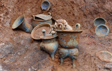 Bronze wares are seen in a sacrificial pit at the Yejiashan Graveyard of the Western Zhou Dynasty (1046-771 BC) in Suizhou city, central Chinas Hubei province, 3 July 2013 clipart