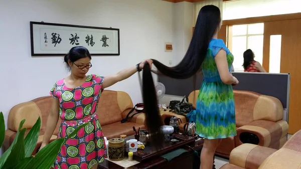 歳のシャオ 深セン市で彼女の2メートル長の髪を示すためにソファの上に立って 南中国広東省 月2014 — ストック写真