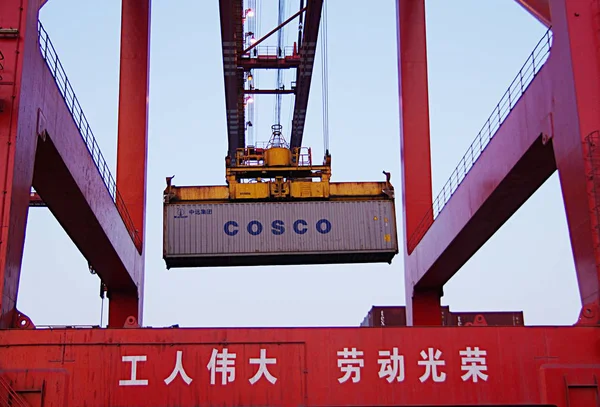 クレーン車は 中国山東省東部のRizhao市のRizhao港でコスコのコンテナを降ろします 2014年4月5日 — ストック写真