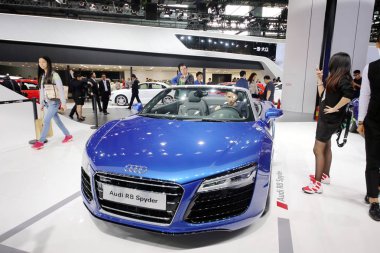 Visitors try out or look at an Audi R8 Spyder on display during the 12th China (Guangzhou) International Automobile Exhibition, known as Auto Guangzhou 2014, in Guangzhou city, south China's Guangdong province, 20 November 2014. clipart