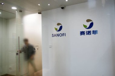 A Chinese employee walks out of the office of Sanofi (China) Investment Co., Ltd. in Shanghai, China, 9 August 2013 clipart