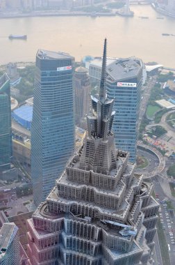 This picture taken from high in the Shanghai World Financial Center shows a view of Puxi, Huangpu River and the Lujiazui Financial District with the Jinmao Tower, front, and other skyscrapers and high-rise buildings in Pudong in Shanghai, China, 7 Se clipart