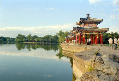Tourists visit the Shuixin Pavilion in the center of Yinhu Lake(Silver Lake) at the Chengde Mountain Resort in Chengde city, north Chinas Hebei province. clipart