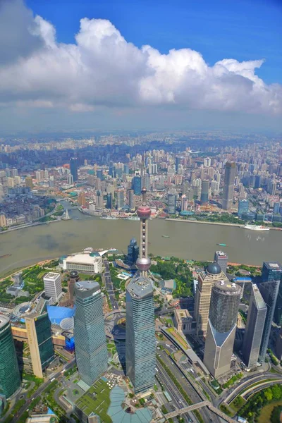 This picture taken from high in the Shanghai Tower under construction shows a view of Puxi, Huangpu River and the Lujiazui Financial District with the Oriental Pearl TV Tower, center tallest, and other skyscrapers and high-rise buildings in Pudong in