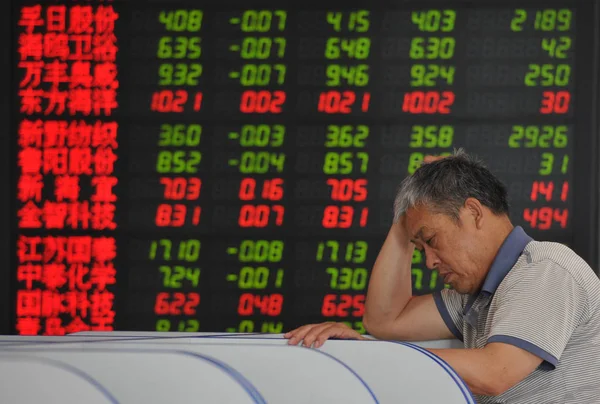 Concerned Chinese Investor Looks Prices Shares Red Price Rising Green — Stock Photo, Image