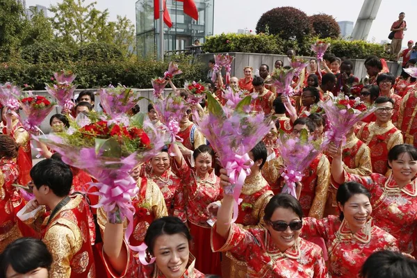 伝統的な中国の衣装を着た新婚夫婦のカップルは 2014年10月6日 中国東部の浙江省杭州市の西湖で集合結婚式を祝う — ストック写真