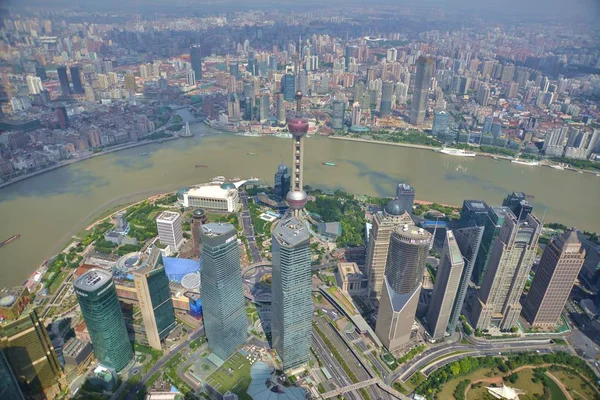 This picture taken from high in the Shanghai Tower under construction shows a view of Puxi, Huangpu River and the Lujiazui Financial District with the Oriental Pearl TV Tower, center tallest, and other skyscrapers and high-rise buildings in Pudong in