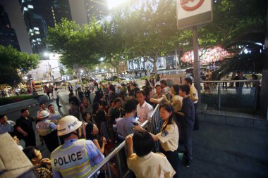 Chinese citizens queue up outside a subway station after three downtown districts of Shanghai were hit by a power outage that lasted about one-and-a-half hours in Shanghai, China, 5 June 2013 clipart