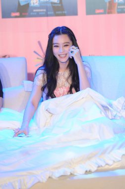 Chinese actress Fan Bingbing smiles during a press conference for her new movie, One Night Surprise, in Beijing, China, 12 July 2013. clipart