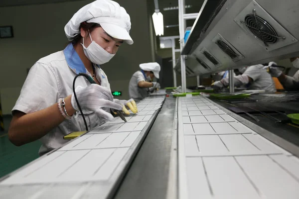 2014年10月9日 中国東部江蘇省梁陽市の江陵郡の工場で 太陽光パネル用太陽光発電セルを溶接し 欧米に輸出する — ストック写真