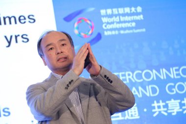 Masayoshi Son, Chairman and CEO of SoftBank Corp., delivers a speech during the First World Internet Conference, also known as Wuzhen Summit, in Wuzhen, an ancient town in Tongxiang city, east China's Zhejiang province, 19 November 2014. clipart