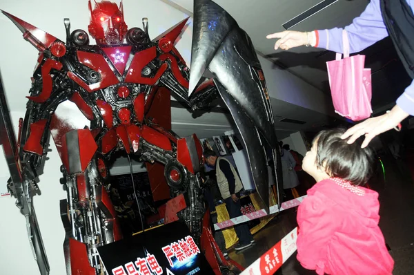 2012年1月12日 在中国海南省海口市举行的变形金刚机器人展上 游客们正在看好莱坞电影 变形金刚 中的机器人人物Sentinel Prime的模型 — 图库照片