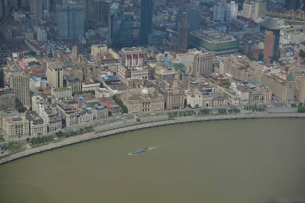 This picture taken from high in the Shanghai Tower under construction in Pudong shows a view of Huangpu River and Puxi with colonial buildings along the promenade on the Bund and other high-rise buildings in Shanghai, China, 30 August 2014.