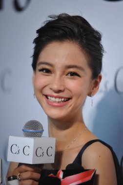 Hong Kong actress and model Angelababy smiles during a press conference for jewelry brand CsC in Beijing, China, 8 July 2013.  clipart