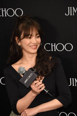 South Korean actress Song Hye-kyo smiles during the opening ceremony for a new boutique of Jimmy Choo in Beijing, China, 14 November 2014. clipart