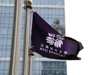 A flag of New York University Shanghai (NYU Shanghai) flutters at the campus of New York University Shanghai (NYU Shanghai) in the Lujiazui Financial District in Pudong, Shanghai, China, 7 August 2014.  clipart