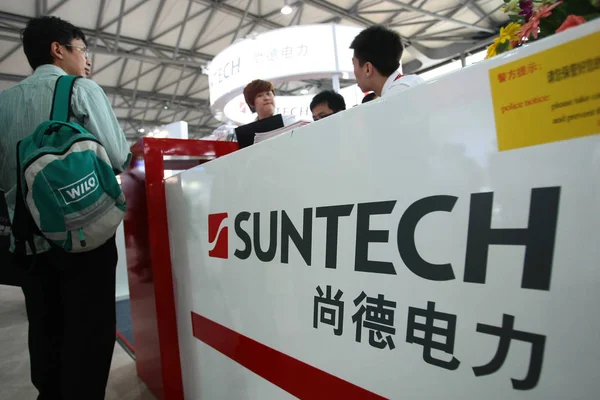 --FILE--People visit the stand of Suntech during the SNEC 6th (2012) International Photovoltaic Power Generation Conference  Exhibition, known as SNEC 2012 PV Power Expo, in Shanghai, China, 16 May 2012