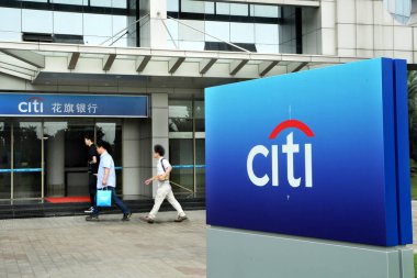 -Pedestrians walk past a branch of Citibank of Citigroup in Pudong, Shanghai, China, 5 June 2014.  clipart