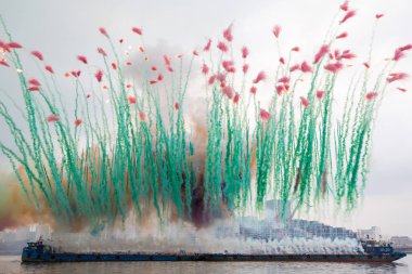 Fireworks explode over the Huangpu River in an ephemeral artwork called Elegy during the Ninth Wave art exhibition by Chinese artist Cai Guoqiang in Shanghai, China, 8 August 2014 clipart