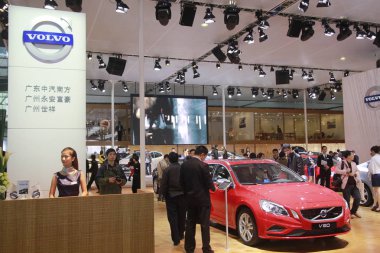 Visitors look at a Volvo V60 during the 10th China (Guangzhou) International Automobile Exhibition, known as Auto Guangzhou 2012, in Guangzhou city, south Chinas Guangdong province, 26 November 2012. clipart