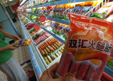 A customer buys Shineway added calcium sausage of Shuanghui Group, now called WH Group, at a supermarket in Yichang city, central Chinas Hubei province, 11 July 2014. clipart