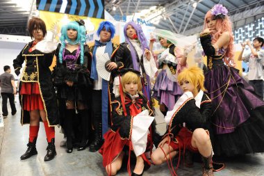 Entertainers dressed in cosplay costumes pose for photos during the 9th China International Cartoon and Games Expo, known as CCG Expo 2013, in Shanghai, China, 11 July 2013 clipart