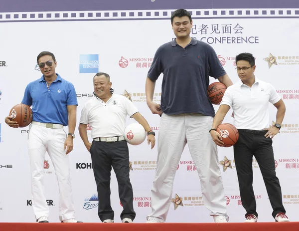 Retired Chinese basketball superstar Yao Ming, right, and his former  teammate Liu Wei, left, pose with a young basketball player during the  launch cer Stock Photo - Alamy