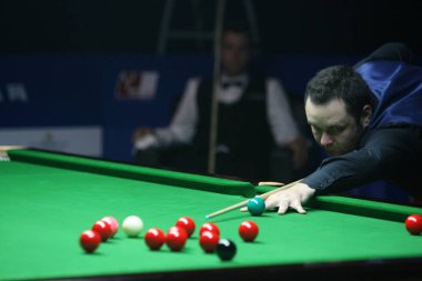 Stephen Maguire of Scotland plays a shot against Jimmy Robertson of England during their first round match of the 2014 World Snooker Shanghai Masters in Shanghai, China, 10 September 2014 clipart