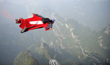 A wingsuit flier competes during the 3rd Red Bull WWL China Grand Prix on Tianmen Mountain in Zhangjiajie city, central China's Hunan province, 14 October 2014 clipart