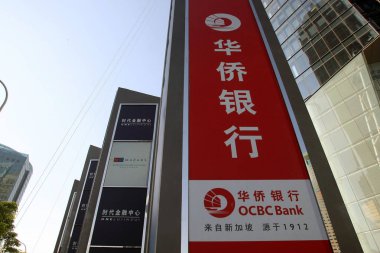 --FILE--View of a signage of OCBC (Oversea-Chinese Banking Corp) in Lujiazui Financial District in Pudong, Shanghai, China, 24 May 2011 clipart