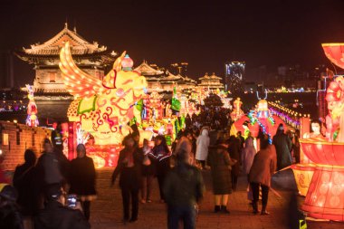 Tourists visit a lantern festival to greet the upcoming Chinese Lunar New Year or Spring Festival in the ancient city of Datong city, north China's Shanxi province, 31 January 2019.    clipart