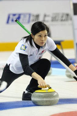 Yumie Funayama of Japan releases a stone in the womens fifth round match against Australia during the Pacific-Asia Curling Championships 2013 in Shanghai, China, 14 November 2013 clipart