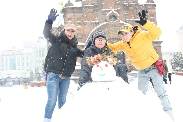 2013年11月18日 在中国东北黑龙江省哈尔滨市 一场暴风雪中 戴着帽子的游客在圣索菲亚教堂前堆雪人 — 图库照片
