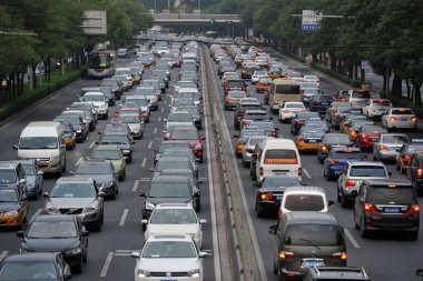 Masses of vehicles move slowly in a traffic jam on a road in Beijing, China, 16 September 2013 clipart