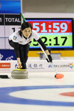 Yumie Funayama of Japan releases a stone in the womens fifth round match against Australia during the Pacific-Asia Curling Championships 2013 in Shanghai, China, 14 November 2013 clipart
