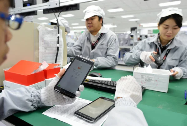 中国の労働者は 武漢市のレノボミッド武漢オペレーションセンターの工場でレノボのスマートフォンをテストします 中国中央湖北省 12月 2013 — ストック写真