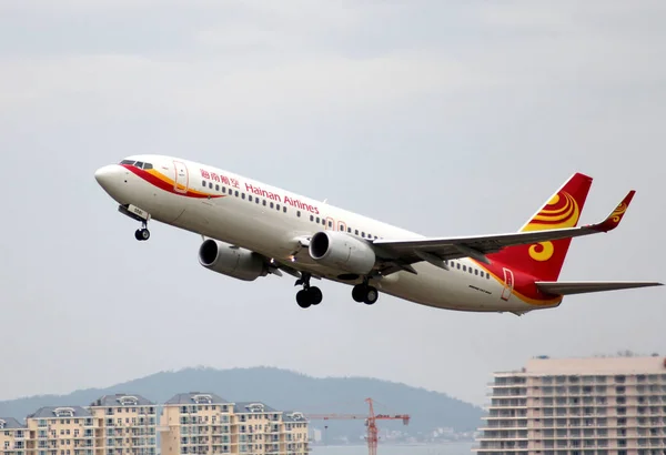 stock image --FILE--A Boeing 737-800 jet plane of Hainan Airlines takes off at the Sanya Phoenix International Airport in Sanya city, south Chinas Hainan province, 3 October 2011