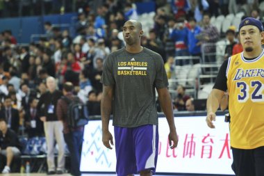 Kobe Bryant of the Los Angeles Lakers warms up during the NBA Fan Appreciation Day event ahead of a 2013-2014 NBA preseason game against the Golden State Warriors in Shanghai, China, 17 October 2013. Lakers will compete against Warriors in two NBA pr clipart
