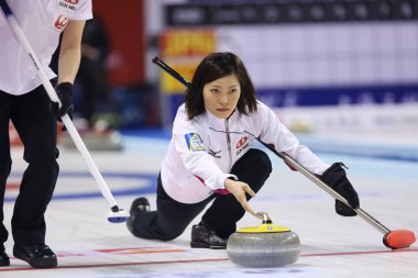Ayumi Ogasawara of Japan releases a stone in the womens seventh round match against New Zealand during the Pacific-Asia Curling Championships 2013 in Shanghai, China, 16 November 2013 clipart