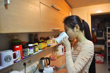 Chinese model Chen Zijia drinks water at home in Beijing, China, 21 November 2013 clipart