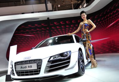 A model poses with an Audi R8 during the 12th Nanjing International Automobile Expo in Nanjing city, east Chinas Jiangsu province, 29 September 2013 clipart