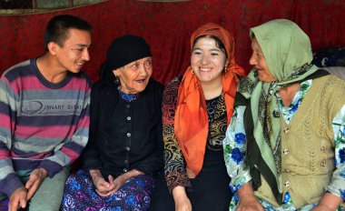 Chinese Uighur woman Ali Mihan, second left, 127 years old, talks with her family members at home in Shule county, Kashgar Prefecture, northwest Chinas Xinjiang Uygur Autonomous Region, 16 August 2013 clipart