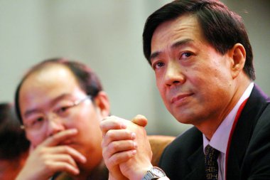 Bo Xilai, right, then Governor of Liaoning province and son of former Chinese Vice Premier Bo Yibo, attends the China Entrepreneur Summit 2003 in Beijing, China, 7 December 2003 clipart