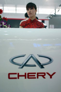 A Chinese staff is seen at the stand of Chery during an auto show in Shanghai, China, 1 November 2011. clipart