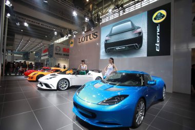 Models pose with Lotus NYO roadsters during the 12th Beijing International Automotive Exhibition, known as Auto China 2012, in Beijing, China, 23 April 2012 clipart