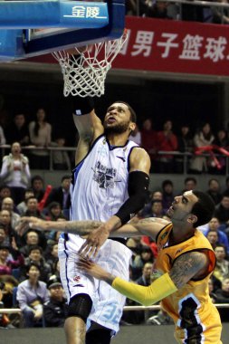 Marcus Williams of Shanxi Zhongyu, right, challenges Randolph Morris of Beijing Ducks in their last semi-final match of the CBA 2011/2012 season in Beijing, China, 18 March 2012 clipart