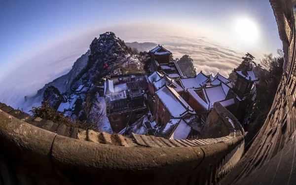 An aerial view of the stonewalled Forbidden City on the Tianzhu Peak (Sky Pillar Peak), also known as the Golden Peak, in snow in the Wudang Mountains in Shiyan city, central China\'s Hubei province, 1 February 2019