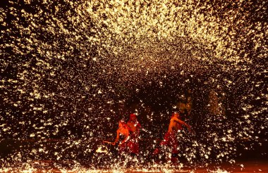 Chinese entertainers perform a fire dragon dance in a shower of molten iron to celebrate the Chinese Lunar New Year, also known as Spring Festival, in Zaozhuang city, east China's Shandong province, 5 February 2019.  clipart