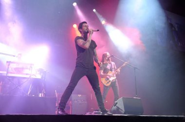 Adam Noah Levine, front, and other members of U.S. pop-rock band Maroon5 performs at a concert during their world tour in Shanghai, China, 25 September 2012 clipart